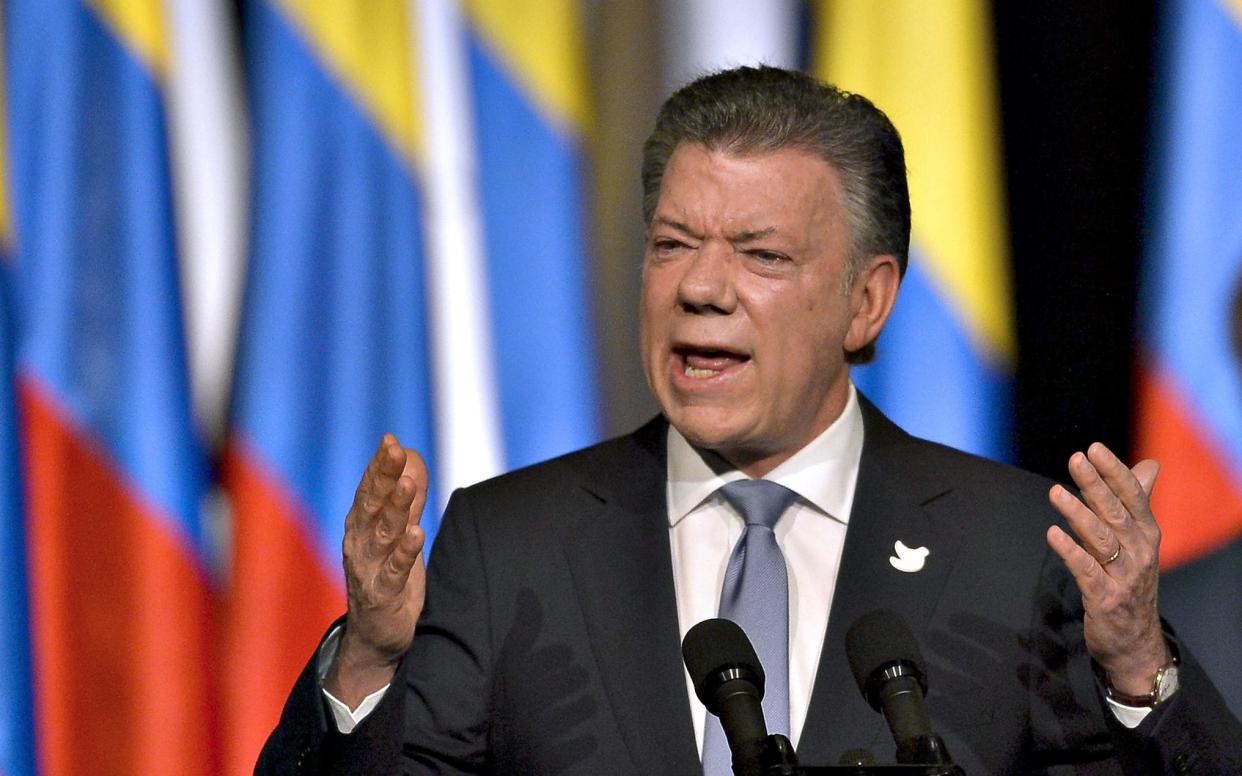 Juan Manuel Santos, the president of Colombia, has announced his country is to join Nato, on the eve of the vote to elect his successor - AFP or licensors