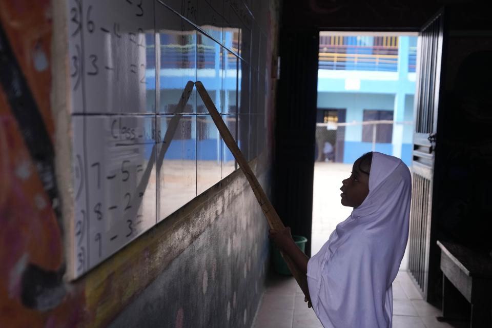 A student of Lorat Nursery and Primary School answers a question on a white board in Ibadan, Nigeria, Tuesday, May 28, 2024. The lack of reliable electricity severely affects education and businesses in Nigeria. (AP Photo/Sunday Alamba)