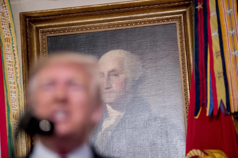 A painting of President George Washington is visible behind President Donald Trump, foreground, as he speaks in the Diplomatic Room of the White House in Washington, Sunday, Oct. 27, 2019, to announce that Islamic State leader Abu Bakr al-Baghdadi has been killed during a US raid in Syria. (AP Photo/Andrew Harnik)