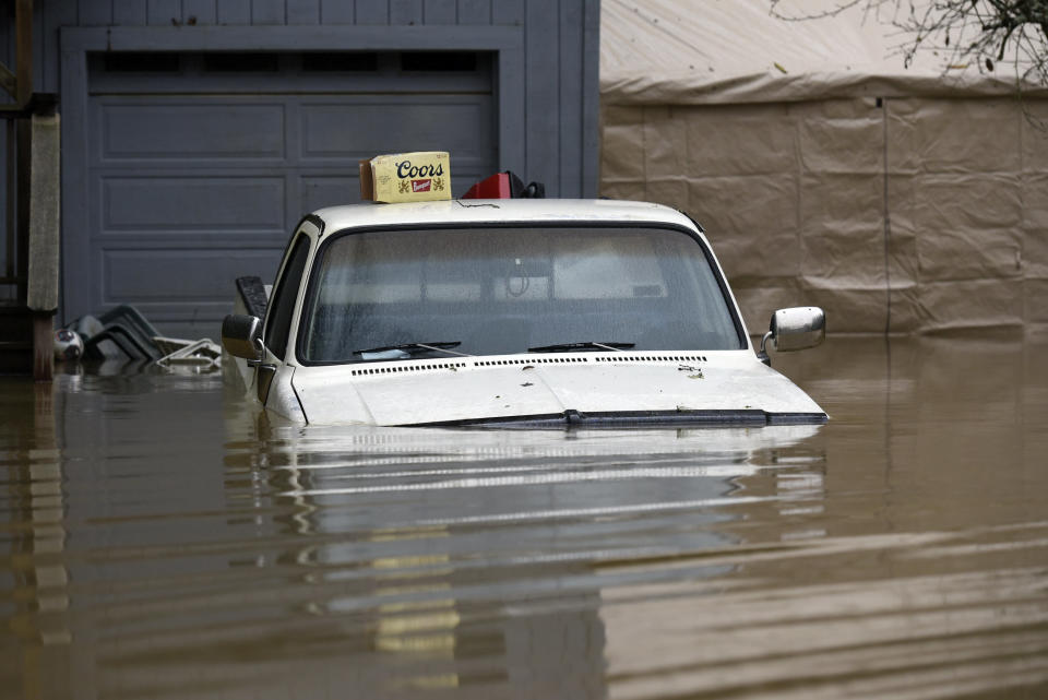 A pickup truck is seen submerged in flood waters from the Russian River in Forestville, Calif., on Feb. 27, 2019. (Photo: Michael Short/AP)