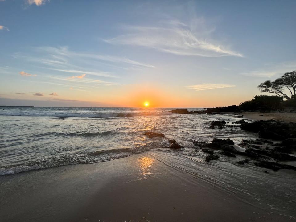 The sun setting on the water horizon of Hapuna Beach