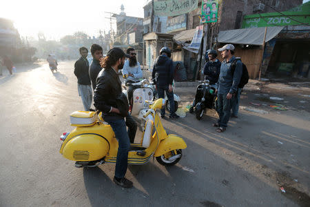 Members of a Vespa rider's club gather at sunrise for a ride in Lahore, Pakistan March 11, 2018. REUTERS/Caren Firouz