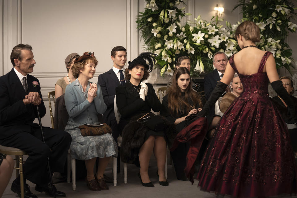 This image released by Focus Features shows Lambert Wilson, from left, Lesley Manville, Guilaine Londez and Dorottya Ilosvai in a scene from "Mrs. Harris Goes to Paris." (Liam Daniel/Focus Features via AP)