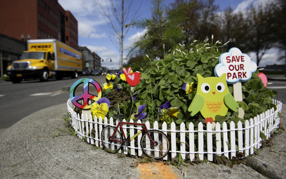 Mill Ends Park sports a myriad of colorful decorations in Portland, Ore., Thursday, April 11, 2013. Tiny battle lines are being drawn in a whimsical British-American dispute over which country has the world’s smallest park. Two feet in diameter, Portland’s Mill Ends Park holds the title of world’s smallest park in the Guinness Book of World Records. But a rival has emerged--Prince’s Park, more than 5,000 miles away in the English town of Burntwood which holds the record for smallest park in the United Kingdom.(AP Photo/Don Ryan)