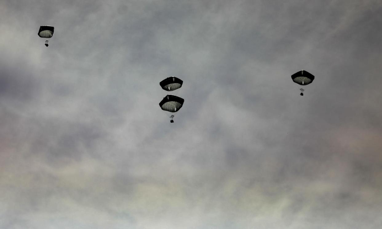 <span>Aid airdrops over Gaza City.</span><span>Photograph: Kosay Al Nemer/Reuters</span>