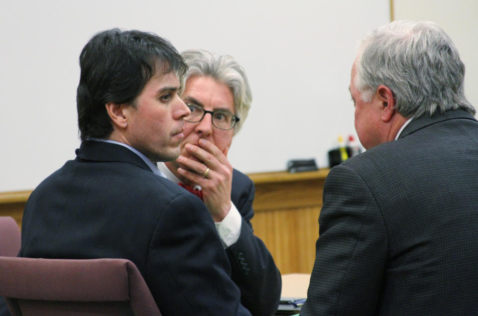 Defense attorneys Charles Groh, center, and Douglas Mullkoff, right, speak to Raulie Wayne Casteel following the jury’s guilty verdict, Wednesday, Jan. 29, 2014 in Howell, Mich. Casteel, 44, of Wixom, Mich.,who said he opened fire on motorists along a busy southeast Michigan highway because he believed they were part of a government conspiracy against him, was convicted of terrorism, assault and other charges. (AP Photo/Livingston County Daily Press & Argus, Lisa Roose-Church, Pool)