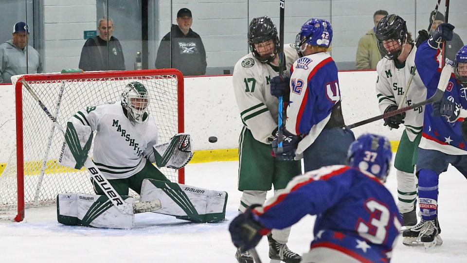Rams goalie Brady Quackenbush keeps his eye on the puck in heavy traffic for the stop.Marshfield Rams boys hockey hosted the Quincy Presidents at the Bog in Kingston on Monday February 21, 2022  