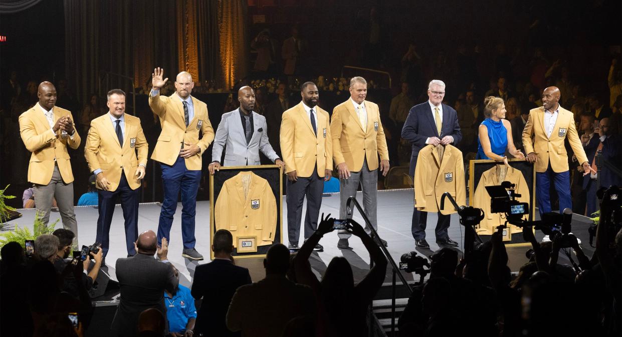 The Pro Football Hall of Fame's Class of 2023 gathers on the stage during the Gold Jacket Dinner on Friday in Canton.