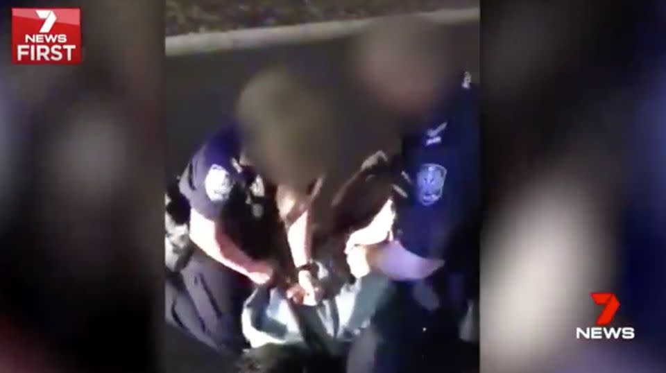 Police were fimed pinning the teenager to the ground outside McDonald's. Source: 7 News