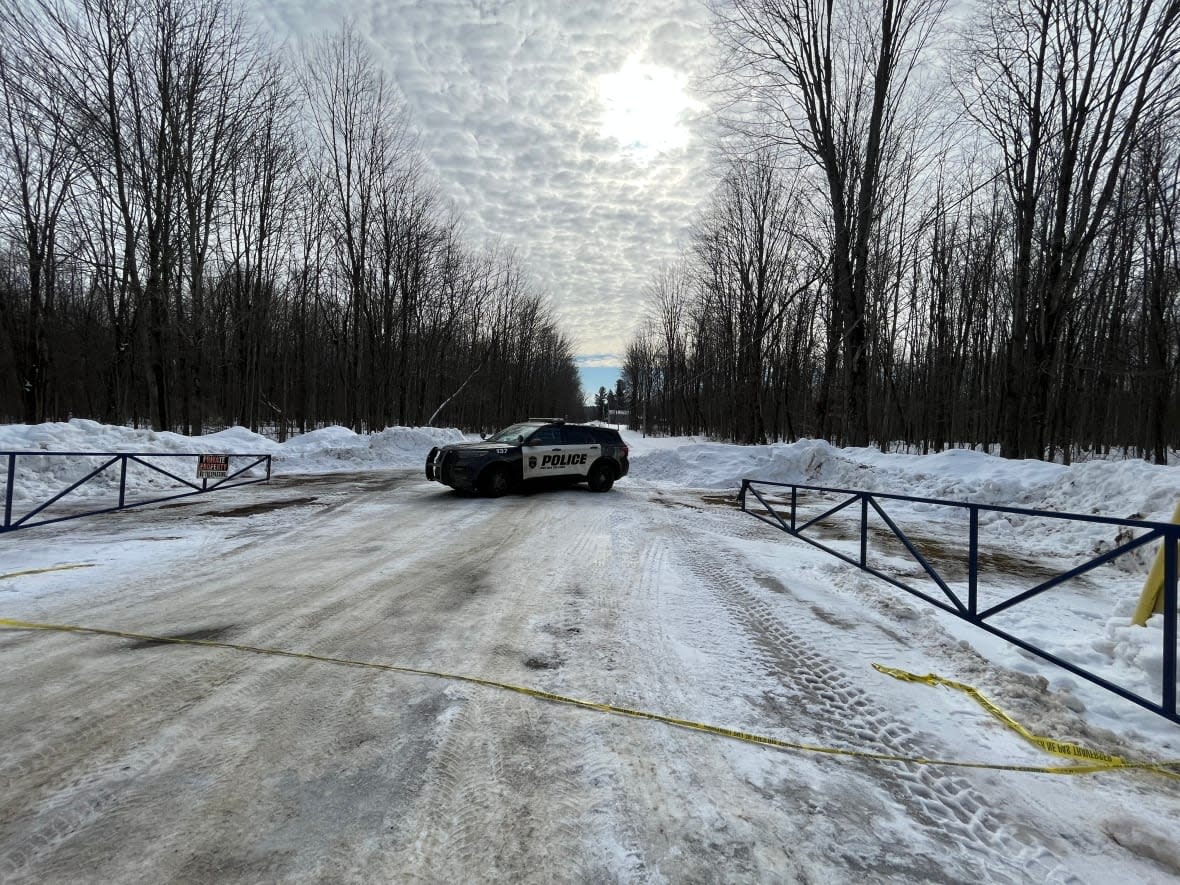 A police vehicle is parked near Camp B'nai Brith of Ottawa on Feb. 12, 2023. Police are investigating what they say are two suspicious fires that broke out overnight at the Jewish summer camp in Quyon, Que. (Camille Kasisi-Monet/Radio-Canada - image credit)