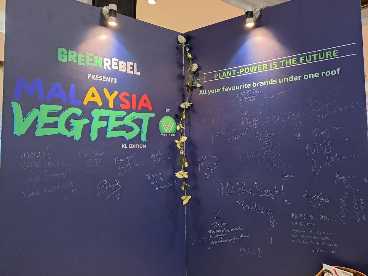 A blue board for Malaysia's Veg Fest for attendees to sign and leave messages. 