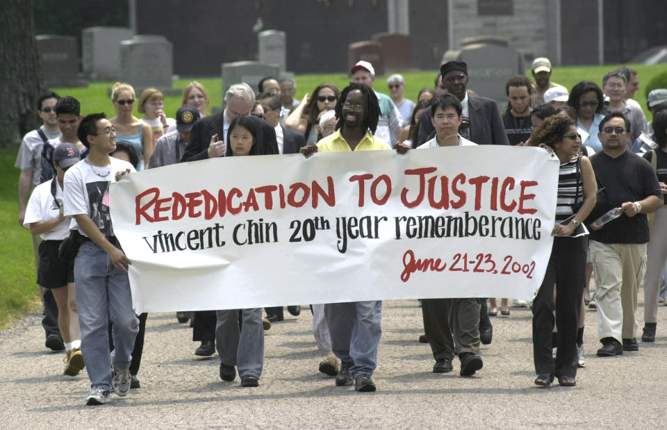 FILE - In this June 23, 2002, file photo, activists walk to the grave of Vincent Chin during a 20th anniversary memorial for Chin at Forest Lawn Cemetery in Detroit. People turning against Asian Americans during the coronavirus pandemic and sputtering economy echoes the climate in 1982, when a 27-year-old Chin was killed in Detroit as laid-off autoworkers blamed a recession on Japanese competition. (AP Photo/Paul Sancya, File)