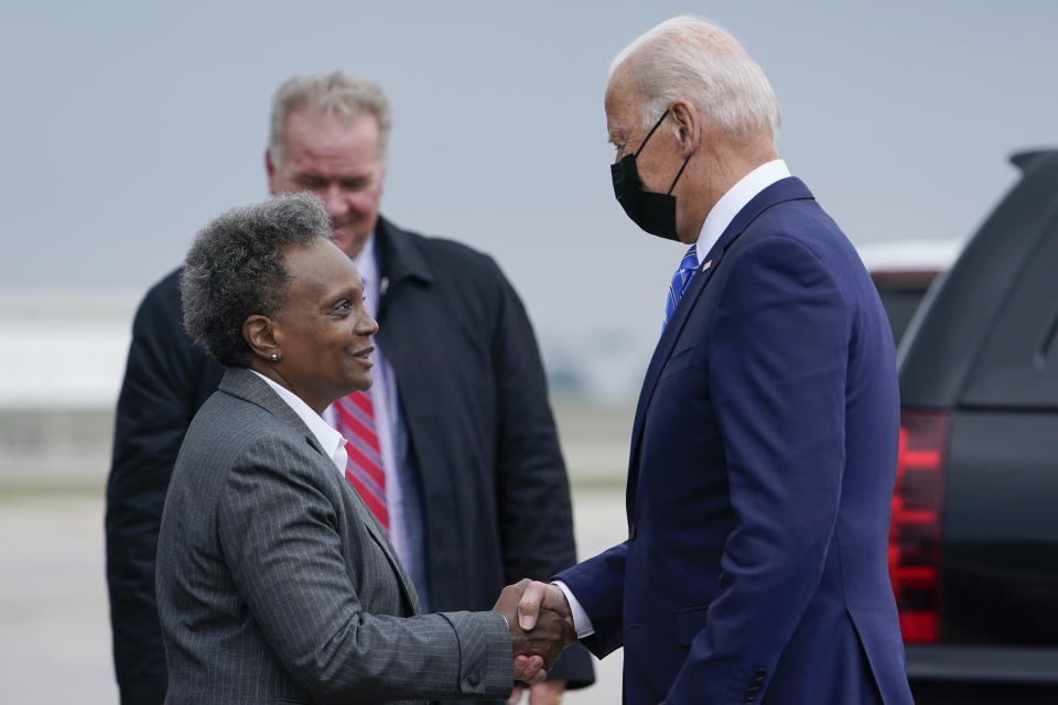 President Joe Biden greets Chicago Mayor Lori Lightfoot at O'Hare International Airport in Chicago, Thursday, Oct. 7, 2021. While in the Chicago area, Biden will highlight his order to require large employers to mandate COVID-19 vaccines for its workers during a visit to a construction site. (AP Photo/Susan Walsh)