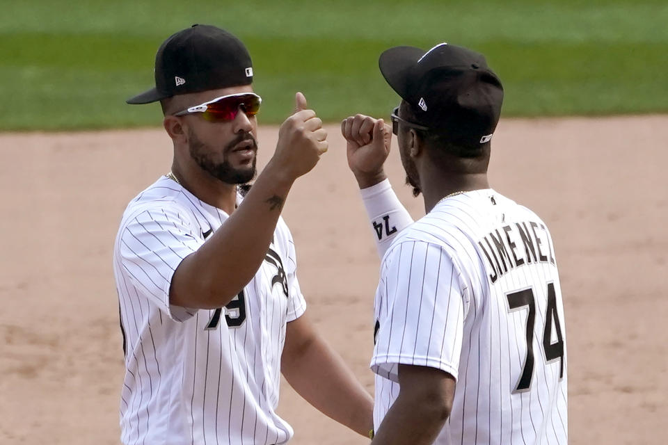 Chicago White Sox's Jose Abreu (79) and Eloy Jimenez celebrate the team's 4-3 win over the Minnesota Twins in a baseball game Thursday, Sept. 17, 2020, in Chicago. The White Sox clinched a playoff spot for the first time since 2008. (AP Photo/Charles Rex Arbogast)