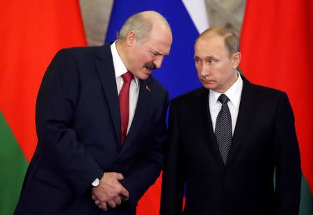 Russia's President Vladimir Putin listens to his Belarussian counterpart Alexander Lukashenko as they attend a signing ceremony during a session of the Supreme State Council of the Union State at the Kremlin in Moscow, March 3, 2015. REUTERS/Sergei Karpukhin/File Photo