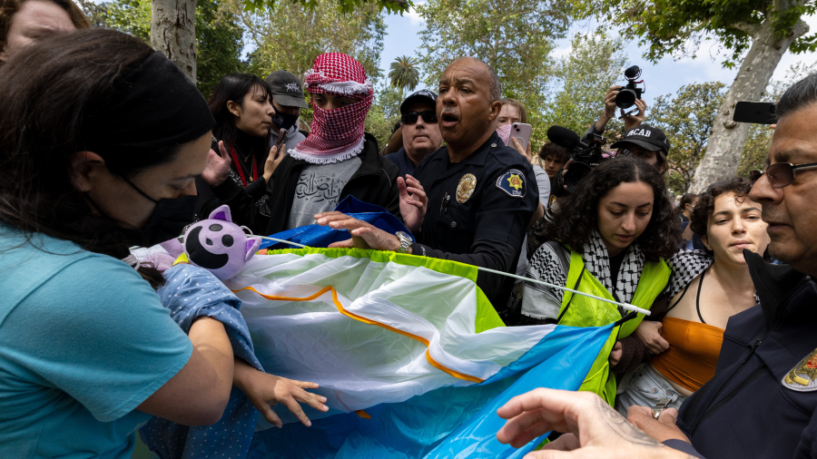 Campus safety officers try to confiscate tents from pro-Palestinian demonstrators at USC on Wednesday, April 24, 2024 in Los Angeles, CA.