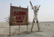 The sign that greets attendees is seen at the gate of the 2013 Burning Man arts and music festival with the year's theme of "Cargo Cult", in the Black Rock Desert of Nevada, August 29, 2013. The federal government issued a permit for 68,000 people from all over the world to gather at the sold out festival, which is celebrating its 27th year, to spend a week in the remote desert cut off from much of the outside world to experience art, music and the unique community that develops. REUTERS/Jim Bourg (UNITED STATES - Tags: SOCIETY) FOR USE WITH BURNING MAN RELATED REPORTING ONLY. FOR EDITORIAL USE ONLY. NOT FOR SALE FOR MARKETING OR ADVERTISING CAMPAIGNS. NO THIRD PARTY SALES. NOT FOR USE BY REUTERS THIRD PARTY DISTRIBUTORS