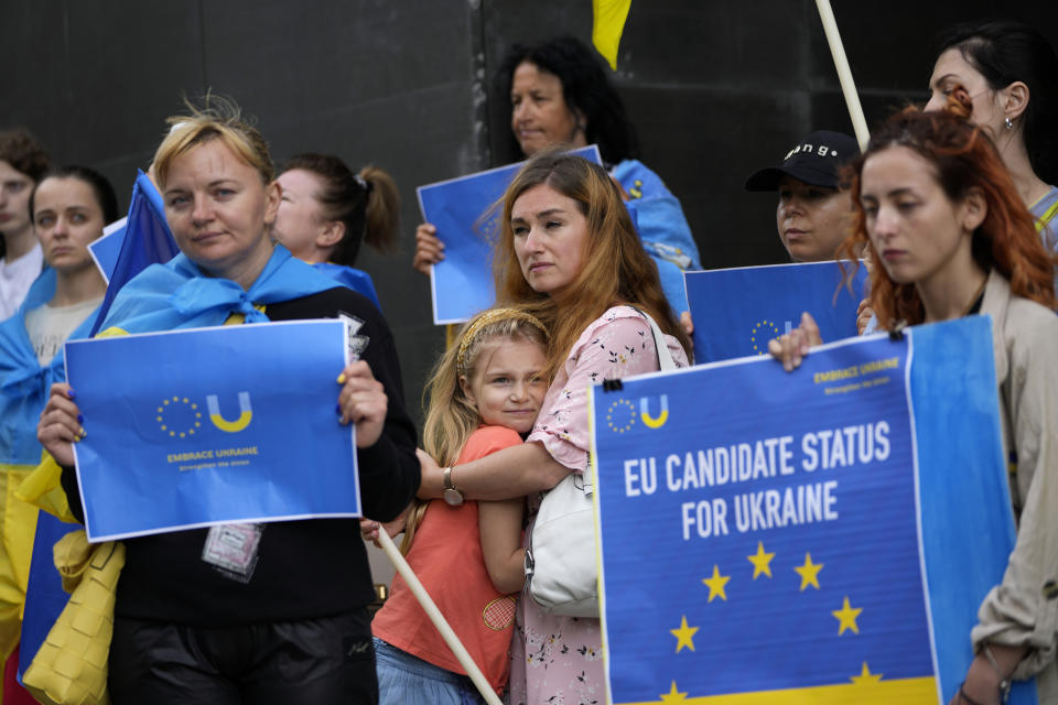 Members of the Ukrainian community in Portugal demonstrate outside the Netherlands embassy in Lisbon in support of Ukraine joining the European Union, Wednesday, June 15, 2022. French President Emmanuel Macron said Wednesday that a "message of support" must be sent to Ukraine before EU heads of state and government "have to make important decisions" at their Brussels meeting. The leaders are scheduled to consider Ukraine's request for EU candidate status. (AP Photo/Armando Franca)