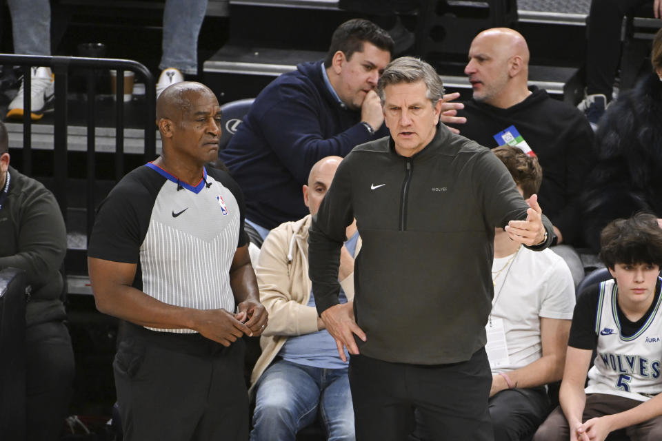 Minnesota Timberwolves coach Chris Finch talks with referee Derrick Collins during a break in play during the second half of the team's NBA basketball game against the Portland Trail Blazers on Friday, Jan. 12, 2024, in Minneapolis. (AP Photo/Craig Lassig)