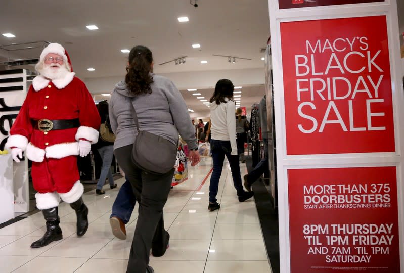 FILE PHOTO: A Santa Claus walks with Black Friday shoppers inside a Macy's store at the Glendale Galleria in Glendale, California