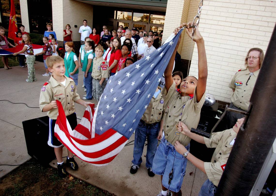 Nov. 10, 2006: Sixth-graders Quentin Query, left, and DeShane Hall with Boy Scouts Troop 76 raise the flag as the student body at Little Elementary School in Arlington gathered for a Veteran’s Day ceremony. R. Jeena Jacob/STAR-TELEGRAM
