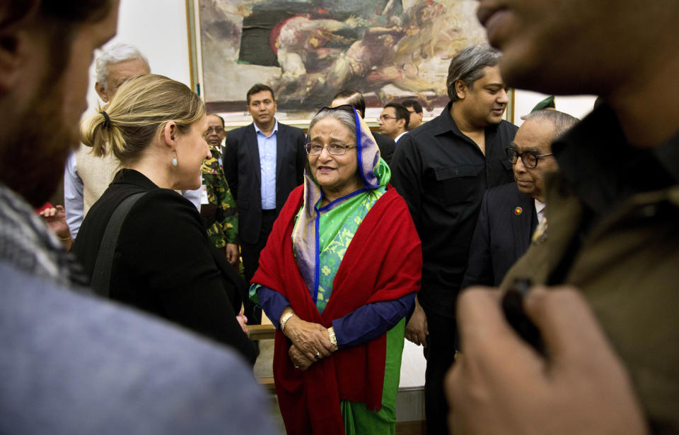 Bangladeshi Prime Minister Sheikh Hasina interacts with journalists in Dhaka, Bangladesh, Monday, Dec. 31, 2018. Bangladesh's ruling alliance won virtually every parliamentary seat in the country's general election, according to official results released Monday, giving Hasina a third straight term despite allegations of intimidation and the opposition disputing the outcome. (AP Photo/Anupam Nath)