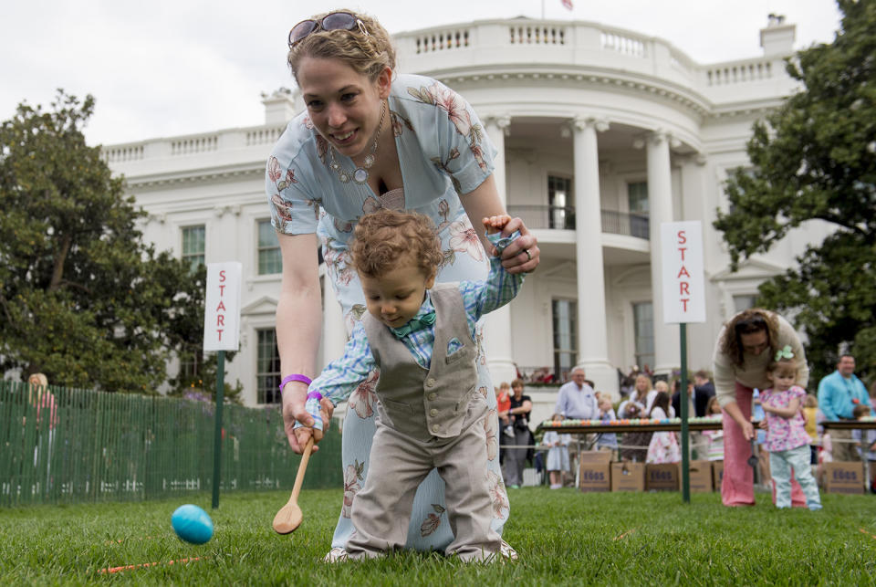 Woman and daughter roll eggs during race