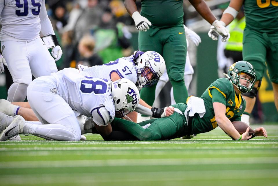 Nov 19, 2022; Waco, Texas, USA; Baylor Bears quarterback Blake Shapen (12) is sacked by TCU Horned Frogs linebacker Johnny Hodges (57) and defensive lineman Dylan Horton (98) during the second quarter at McLane Stadium.