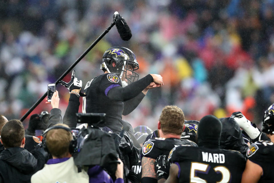 Baltimore Ravens teammates carry kicker Justin Tucker off the field after his 49-yard game-winning field goal. (Rob Carr/Getty Images)