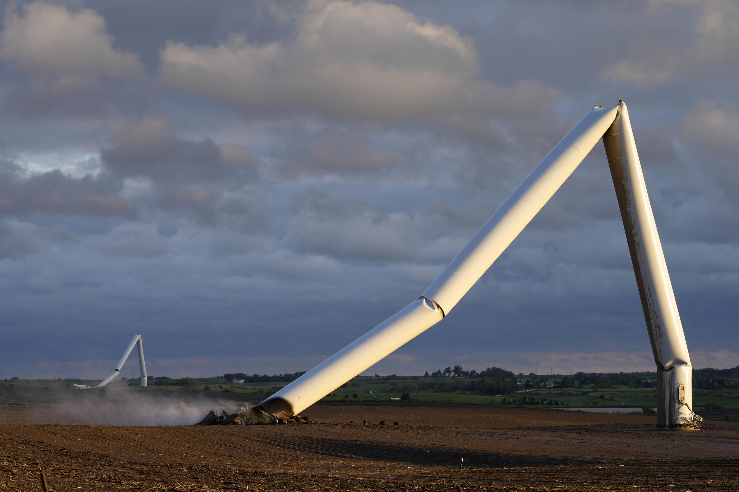 The remains of a tornado-damaged wind turbine touch the ground in a field on Tuesday, near Prescott, Iowa. (Charlie Neibergall/AP)