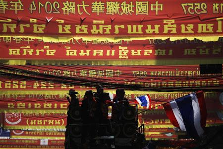 Anti-government protesters wave flags from atop a truck during a march through Chinatown in Bangkok February 1, 2014. REUTERS/Damir Sagolj