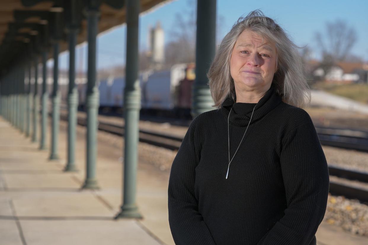 Terri Brewer, a Bristol resident, poses for a portrait outside the town's historic train station. As a teenager, she was taken by her parents to get an abortion and now feels the date of that event marks a birthday she can't celebrate.