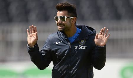 Virat Kohli gestures during a training session before the fourth cricket test match against England at the Old Trafford cricket ground, Manchester, England August 6, 2014. REUTERS/Philip Brown