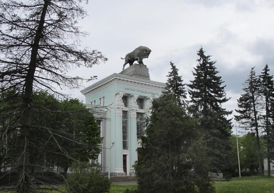 This May 13, 2012 photo shows a sculpture of a bull appearing to charge off the roof of a pavilion at the All-Russia Exhibition Center in Moscow. The pavilion is part of the former massive display of Soviet achievements, which now has become a hybrid of state fair, shopping center and recreation area that is one of Moscow’s most popular free attractions. (AP Photo/Jim Heintz)