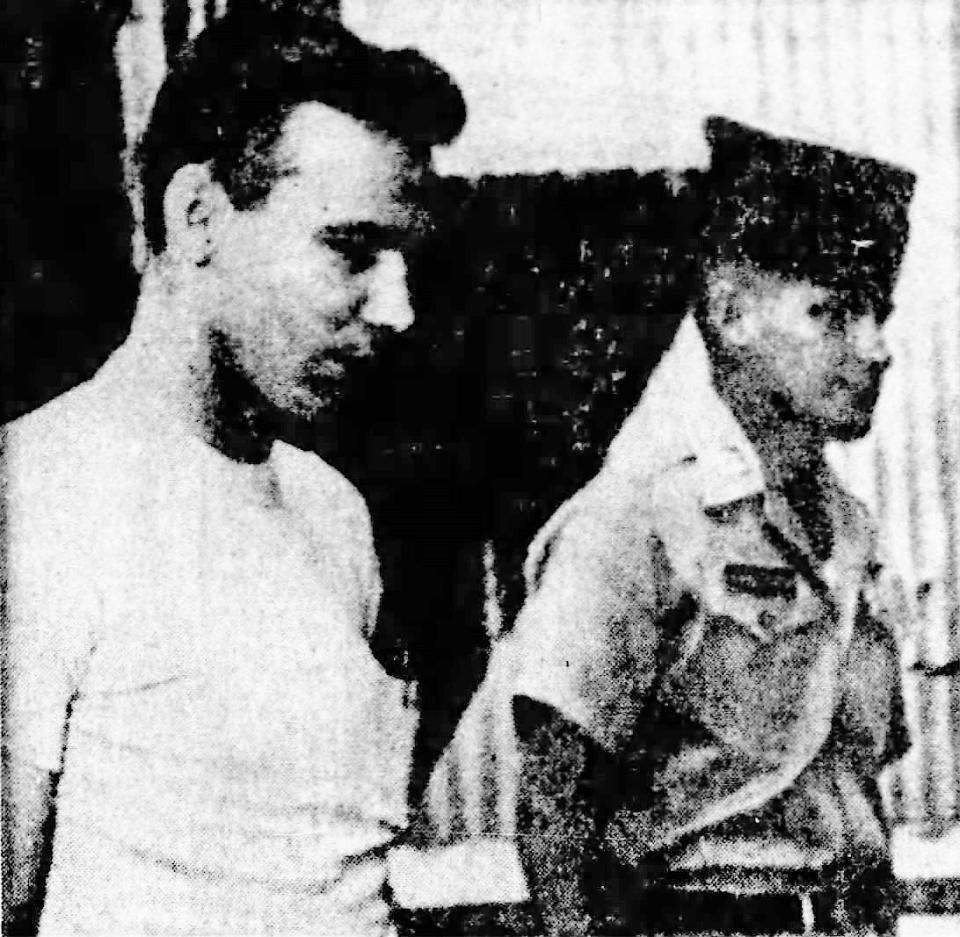 Pvt. Willie J. King (left) of Galveston, Texas, is returned to civilian authorities in Muscogee, Okla. He is accompanied by Capt. Andrew Kirkpatrick.