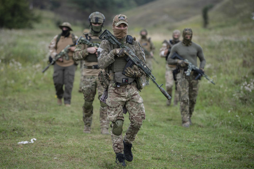 FILE - Volunteer soldiers attend a training outside Kyiv, Ukraine, Saturday, Aug. 27, 2022. As the war slogs on, a growing flow of Western weapons over the summer is now playing a key role in the counteroffensive, helping Ukraine significantly boost its precision strike capability. (AP Photo/Andrew Kravchenko, File)