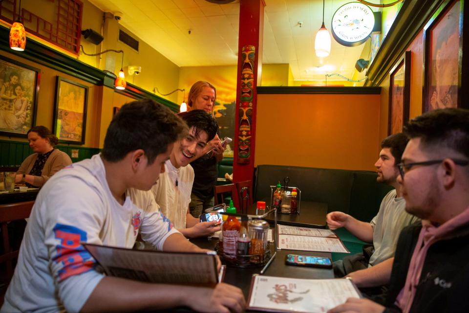 East High School seniors Jesus Aviles DeLeon, Bryan Robles, Diego Lopez-Martinez and Steven Magaña order lunch at Fong's Pizza in Des Moines on Wednesday, May 18, 2022. The group of friends will be graduating from East this spring.