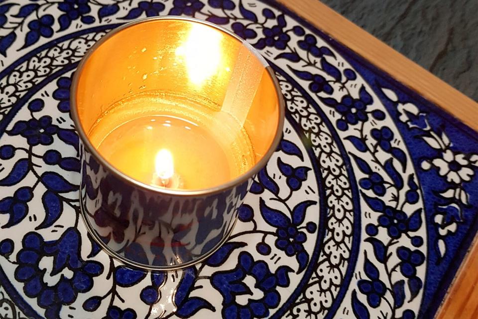 A yahrzeit candle, or memorial candle (Heb. 'ner neshama', 'soul candle'), lit in memory of the deceased person at the anniversary date of his passing (Hebrew calendar and day beginning at sundown in accordance with Genesis 1:5: "And there was evening and there was morning, one day.") Also lit the days when 'Yizkor' is said - before the sundown of day when it is said (Yom Kippur, Shemini Atzeret, final day of Pesach, Shavuot). Also during the shiva. The custom of lighting a yahrzeit candle comes from the Book of Proverbs 20:27 by King Shlomo "The soul of man is a candle of the Lord."