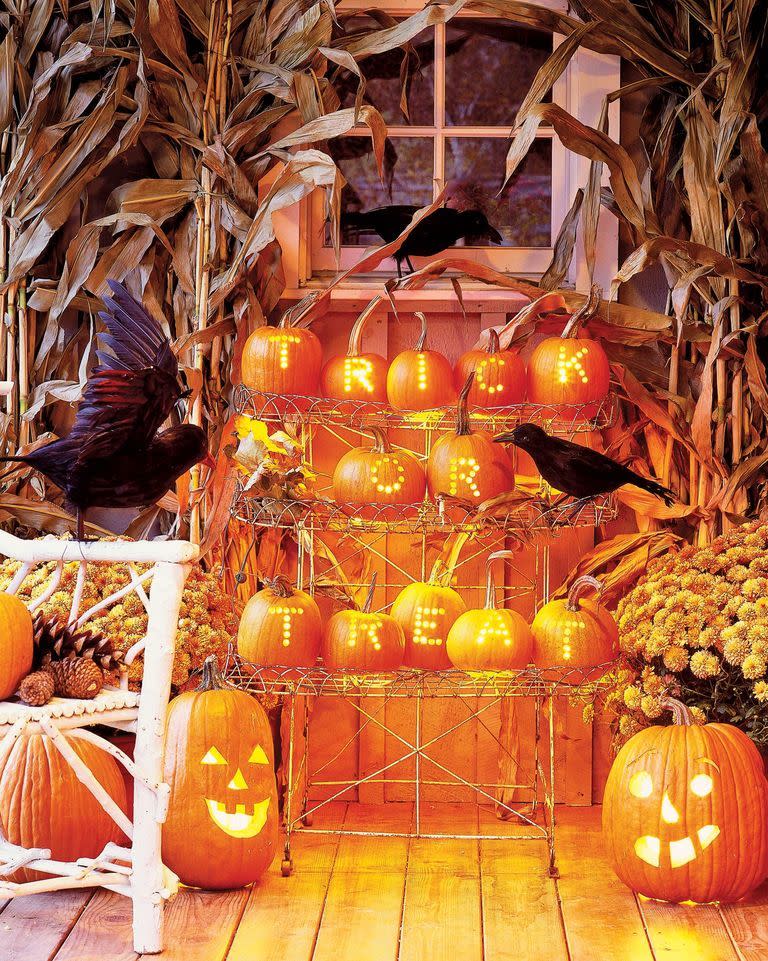 <p>This statement-making display doesn't require you to be a pumpkin-carving expert. Instead, you can cheat with a drill. First, pencil your letters onto hollowed pumpkins (carve out the opening from the bottom). Next, use a drill with a half-inch bit to create holes that form each letter. Use a string of Christmas-tree lights, gathered in small bunches, to illuminate each pumpkin (unscrew the bulbs where the string descends to the next row).</p>