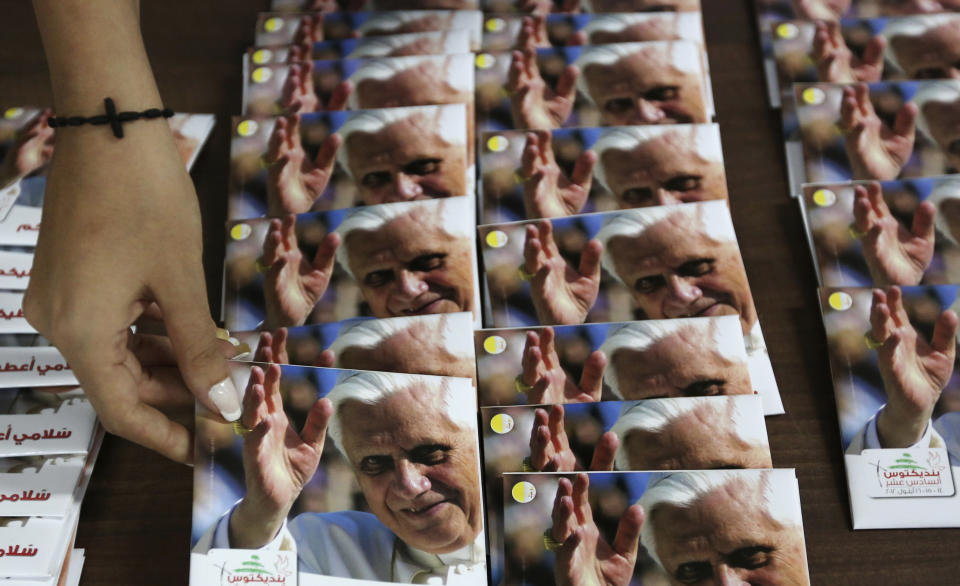 A woman holds compact discs containing religious hymns of Pope Benedict XVI in preparation for his arrival for a three-day visit to Lebanon, in a papal media office in Jounieh, north of Beirut September 4, 2012. Pope Benedict XVI will visit Lebanon from September 14-16. REUTERS/ Jamal Saidi          (LEBANON - Tags: RELIGION)