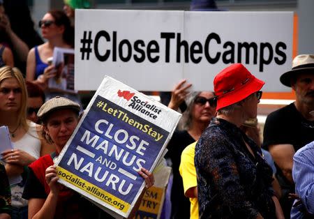 Protesters from the Refugee Action Coalition hold placards during a demonstration outside the offices of the Australian Government Department of Immigration and Border Protection in Sydney, Australia, April 29, 2016. REUTERS/David Gray