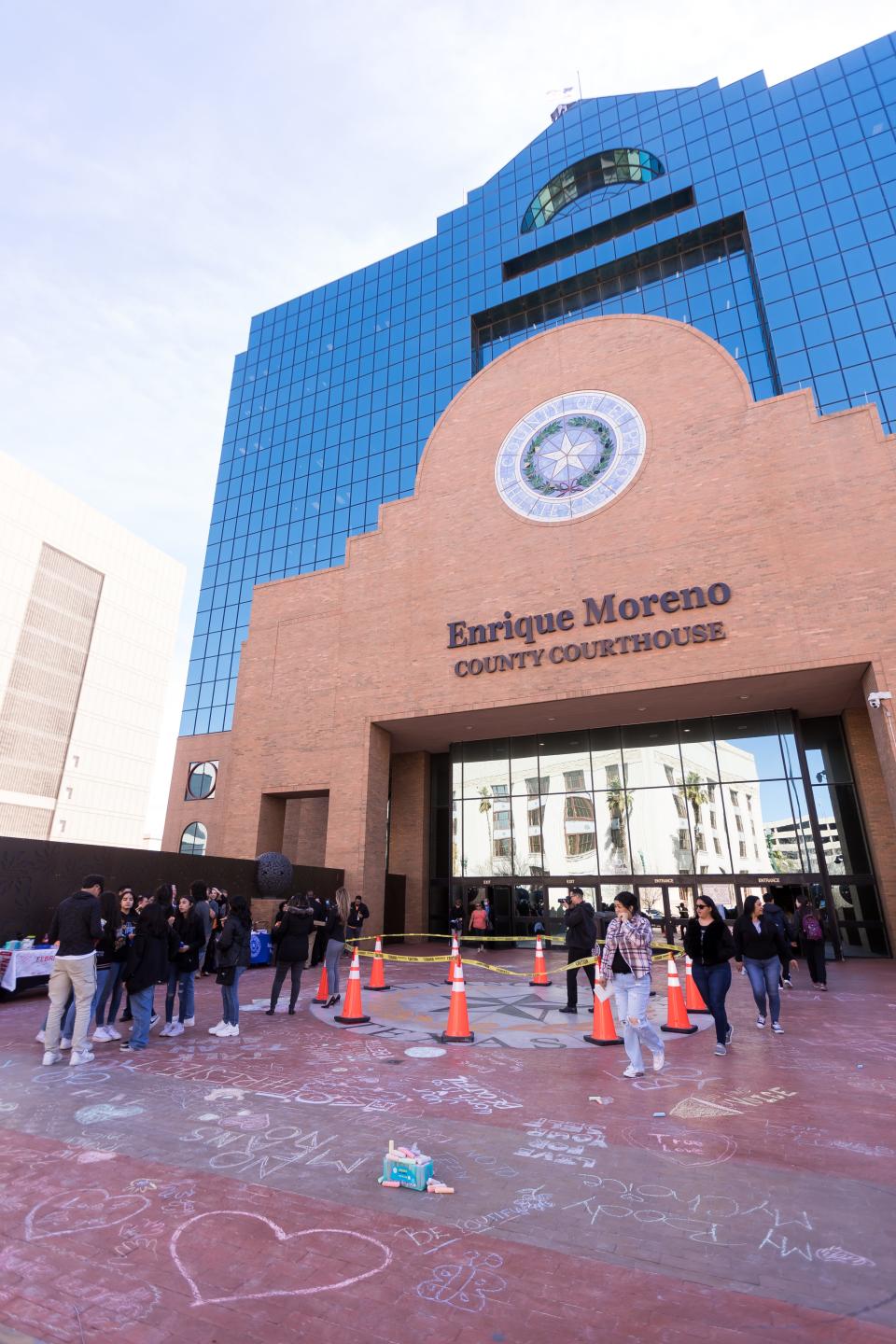 Hanks High School students write temporary messages of hope in chalk in front of the El Paso County Courthouse on Feb. 28 for those seeking support at a dating abuse awareness event. Many county services will be closed Tuesday in observance of the July Fourth holiday.