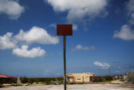 <p>An empty basketball hoop and backboard is seen among homes in ruin at Codrington on the island of Barbuda just after a month after Hurricane Irma struck the Caribbean islands of Antigua and Barbuda, October 7, 2017. REUTERS/Shannon Stapleton </p>