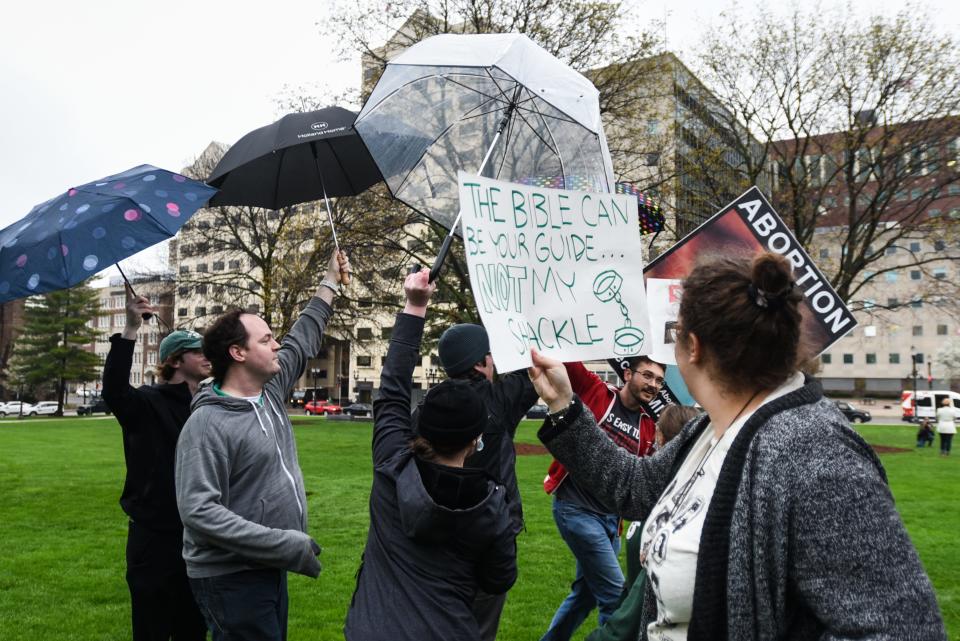 People try to block an anti-abortion counter-protesters during a rally at the state Capitol in Lansing, Mich., Tuesday, May 2, 2022. [AP Photo/Matthew Dae Smith via Lansing State Journal]