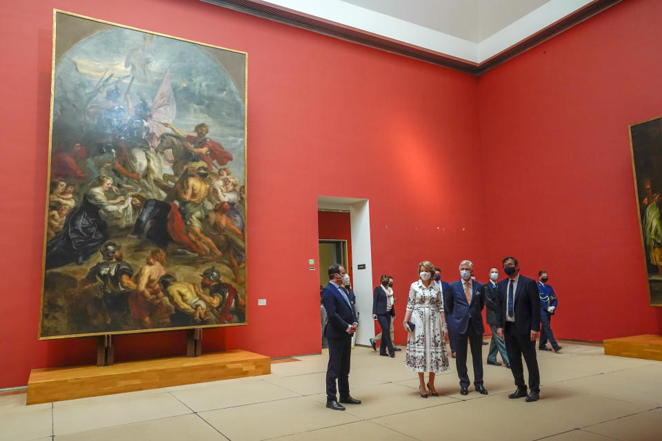 Belgium's King Philippe, center right, and Belgium's Queen Mathilde, center left, wear face masks, to prevent the spread of coronavirus, as they visit the Royal Museum of Fine Arts in Brussels, Tuesday, May 19, 2020. Museums are hesitantly starting to reopen as the coronavirus lockdown measures are relaxed, yet experts say that one in eight in the world could potentially face permanent closure because of the pandemic. (Daina Le Lardic, Pool Photo via AP)