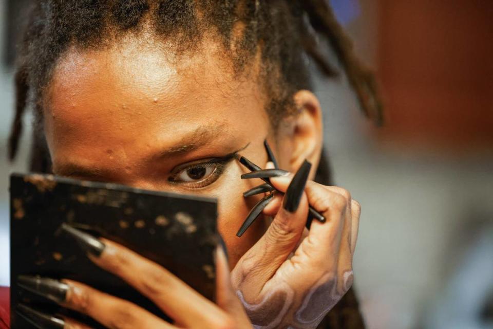 Nyla Wallace, who is legally blind, applies eyeliner using a mirror held close to her face. Wallace has retinitis pigmentosa (RP), a group of rare eye diseases that affect the retina (the light-sensitive layer of tissue in the back of the eye). RP makes cells in the retina break down slowly over time, causing vision loss.