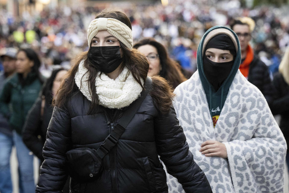 People walk along the 134th Rose Parade route in Pasadena, Calif., Monday, Jan. 2, 2023. (Sarah Reingewirtz/The Orange County Register via AP)