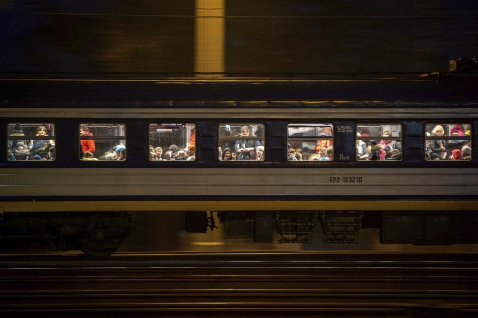 FILE - A train with refugees fleeing Ukraine crosses the border in Medyka, Poland, Monday, March 7, 2022. As milestones go, the first anniversary of Russia's invasion of Ukraine is both grim and vexing. It marks a full year of killing, destruction, loss and pain felt even beyond the borders of Russia and Ukraine. (AP Photo/Visar Kryeziu, File)