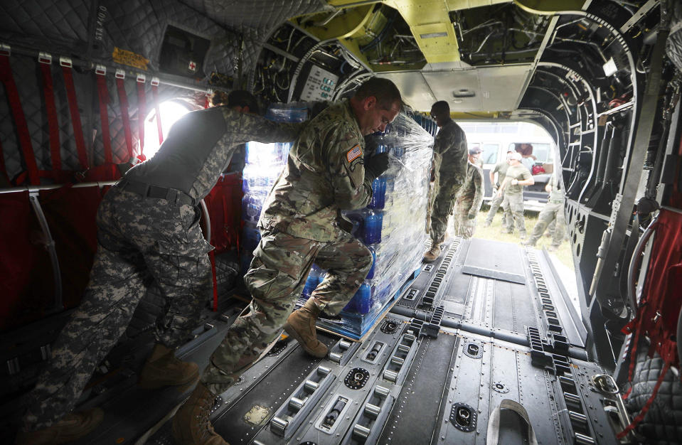 <p>U.S Army soldiers offload bottled water from a helicopter during recovery efforts four weeks after Hurricane Maria struck on Oct. 18, 2017 in Utuado, Puerto Rico. U.S. soldiers and agents delivered food and water provided by FEMA to remote residents in mountainous Utuado. (Photo: Mario Tama/Getty Images) </p>