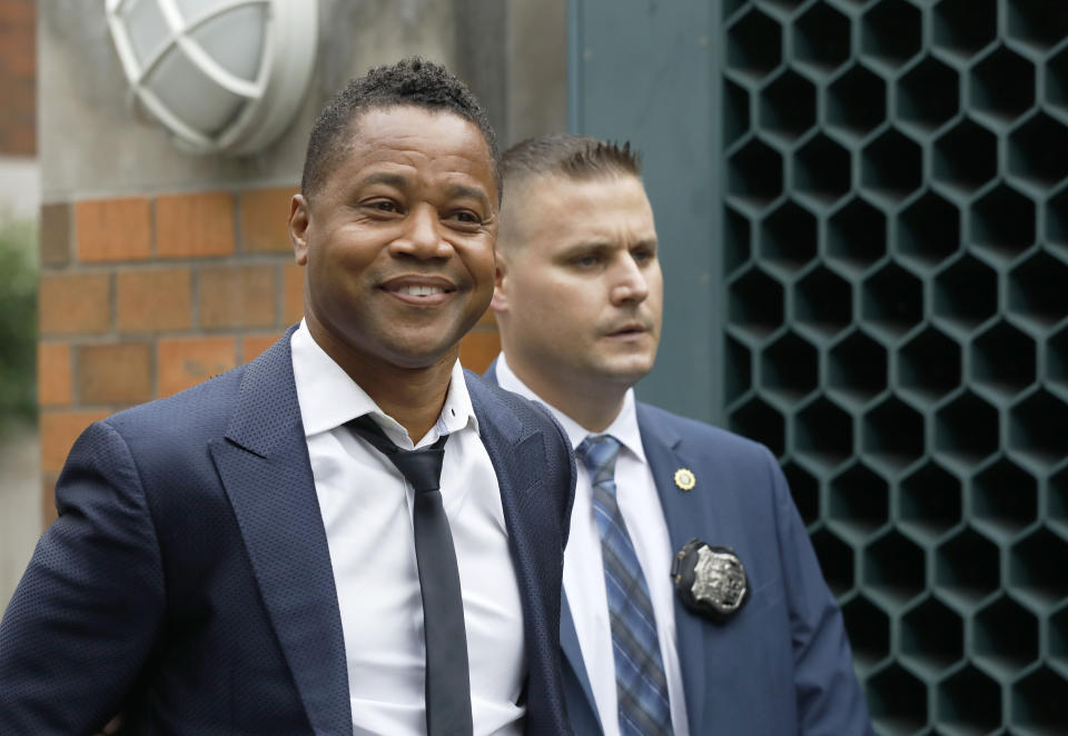 Actor Cuba Gooding Jr., left, is lead by a police officer from New York's Special Victim's Unit, Thursday, June 13, 2019. Gooding Jr. faces allegations he groped a woman at a city night spot. A 29-year-old woman told police the 51-year-old Gooding grabbed her breast while he was intoxicated around 11:15 p.m. Sunday. Gooding denies the allegations. (AP Photo/Mark Lennihan)